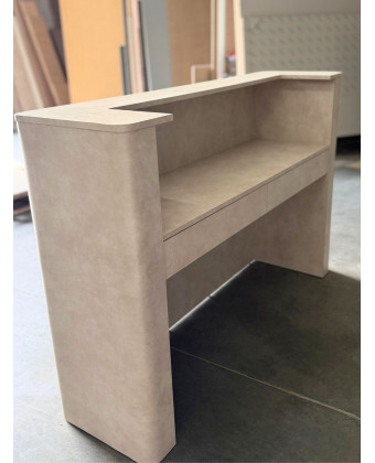 Rounded stone reception desk for a showroom