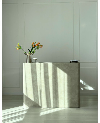 Rounded stone reception desk for a showroom
